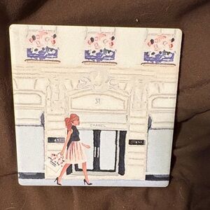 CHANEL Elegant Illustrated Coaster with Black and Cream Accents